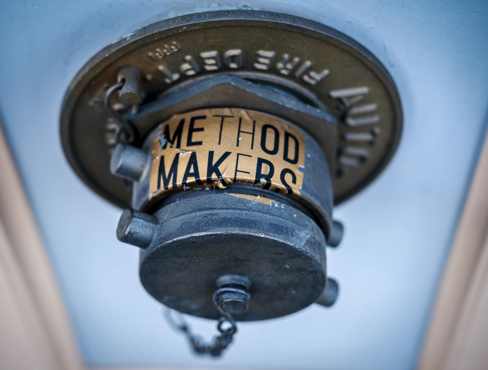 Blue vintage fire sprinkler head with metallic texture and Method Makers label.